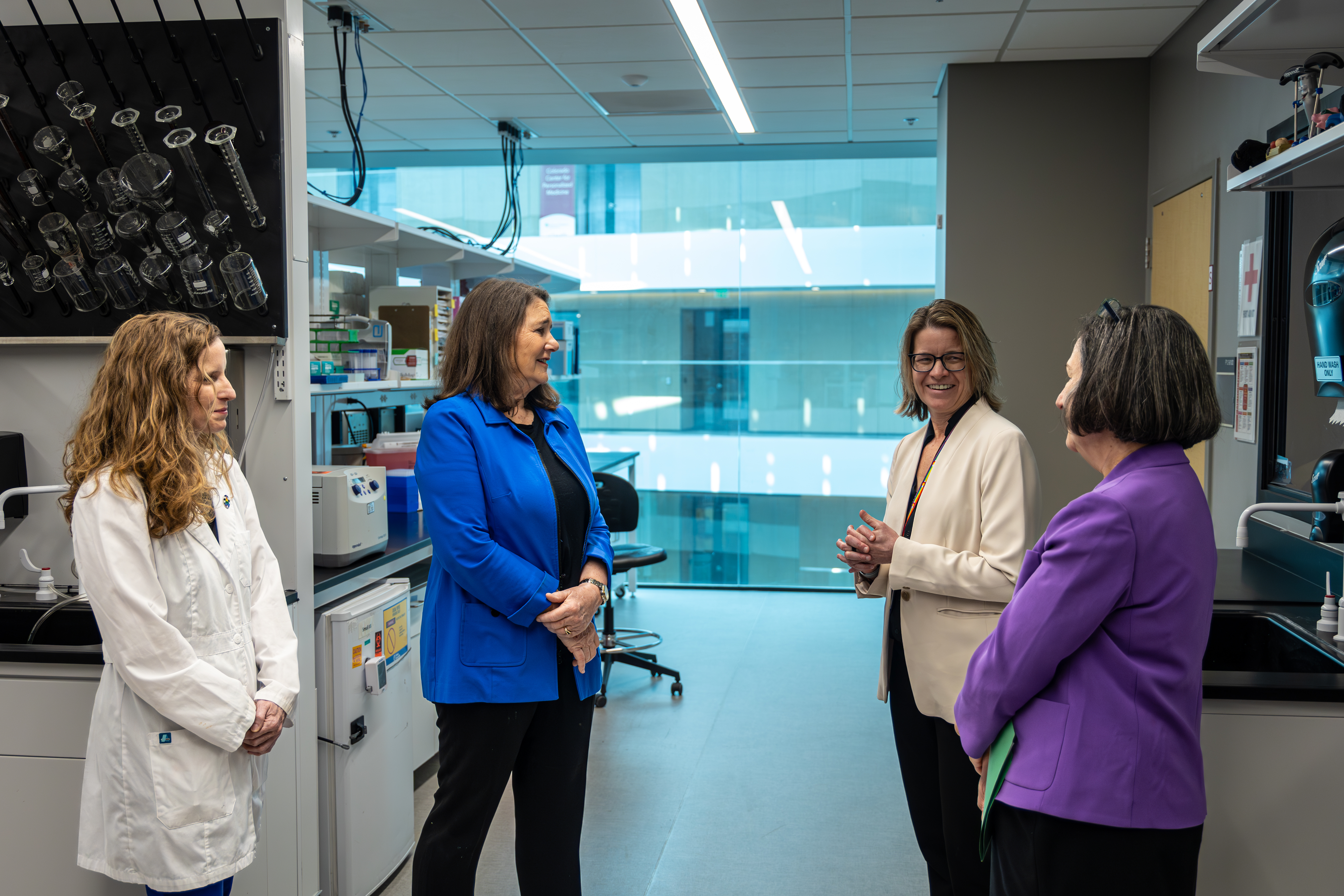 Lab manager Rebecca Baldermann, Rep. Diana DeGette (D-CO), Professor Kerrie Moreau and Ludeman Center Director Judy Regensteiner tour the Core Lab of the Colorado Clinical and Translational Sciences Institute (CCTSI) speaking