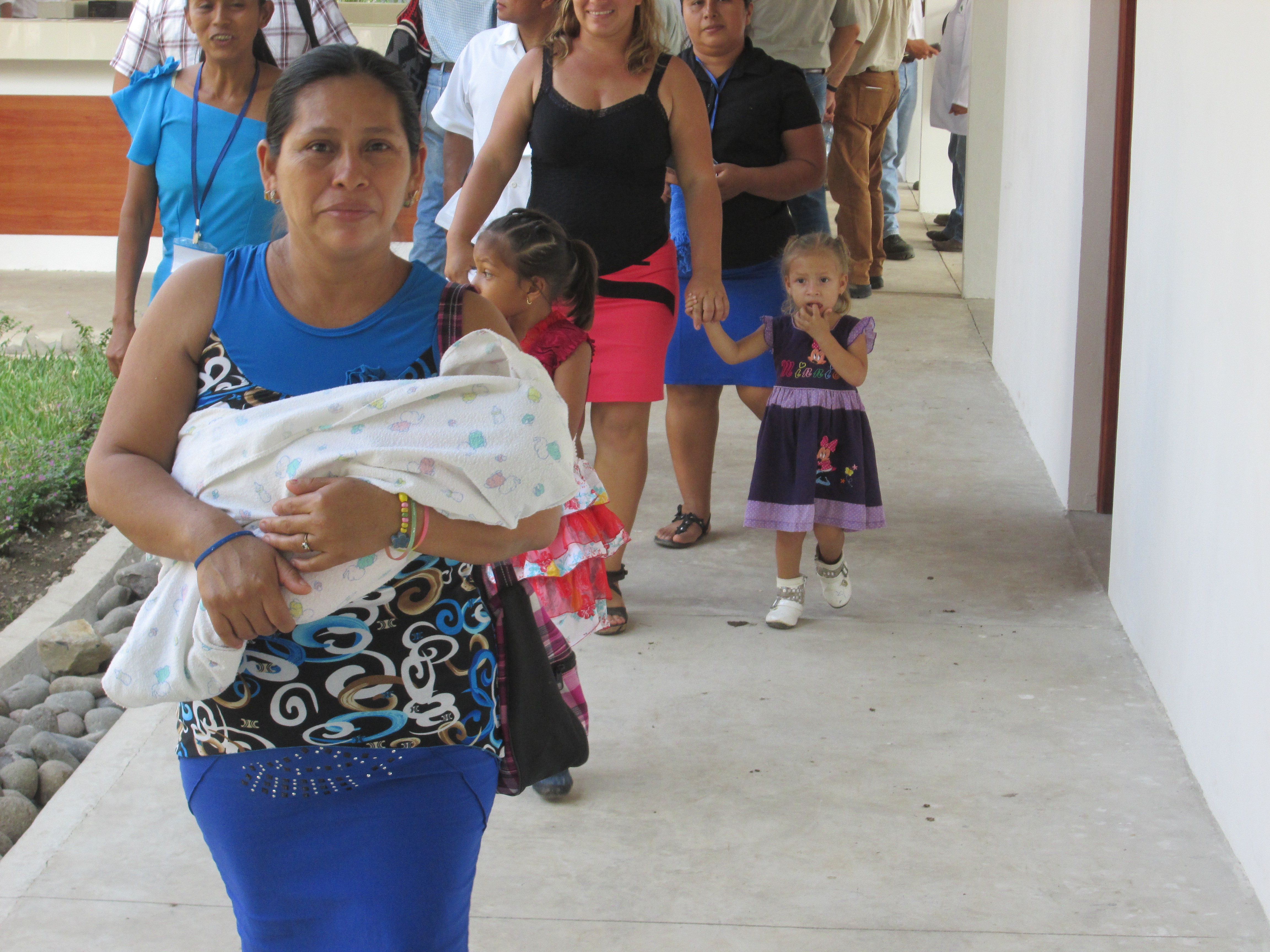 A Guatemalan woman holds a baby at the launch of the CU medical clinic