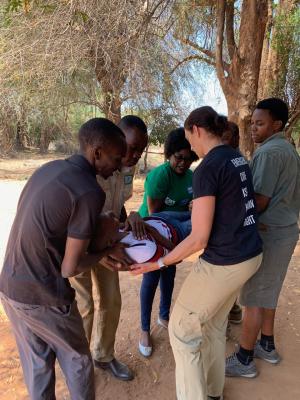 Dr. Calvello Hynes instructs lay providers in how to safely carry an injured patient out of a vehicle.